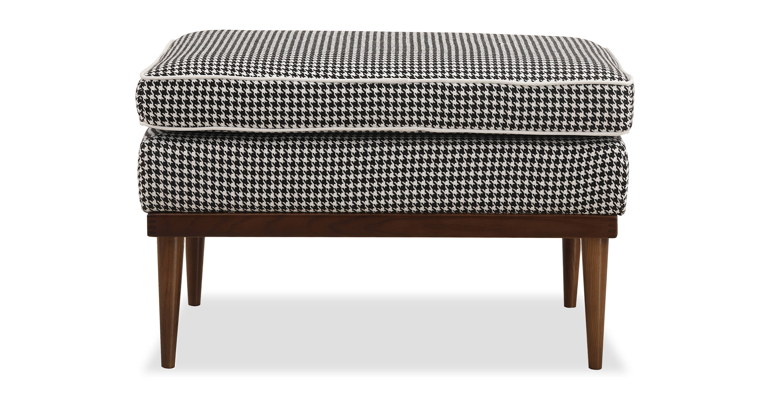 Elektra Houndstooth rectangle ottoman with exposed walnut frame and legs. Black and white houndstooth pattern is present on the base and top ottoman cushion. Style is modern and sophisticated. 